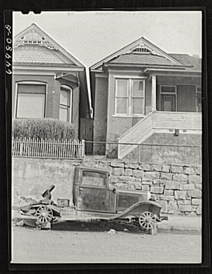 Truck stripped of tires in front of house